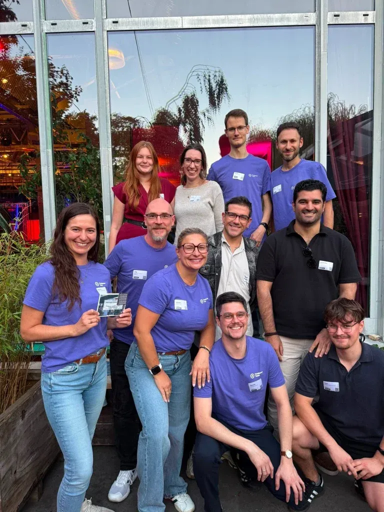 Das Freelancer Team in lila T-Shirts beim Überstunde Afterwork Event in Berlin